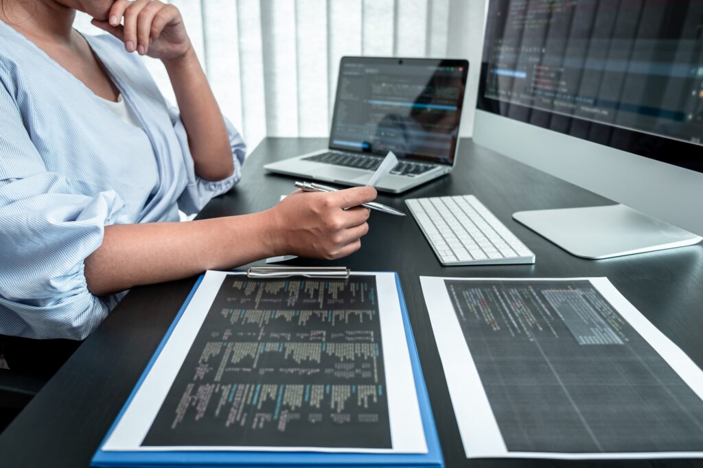 Programmer working in software javascript computer in IT office, Writing codes and data code website